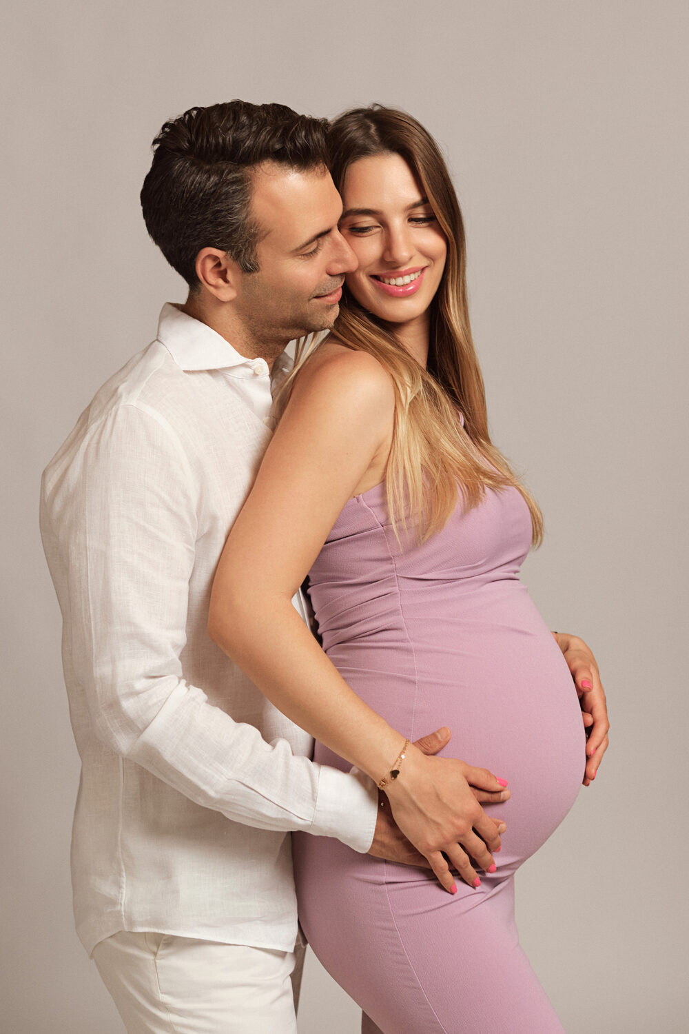 Maternity session in studio — couple expecting a baby