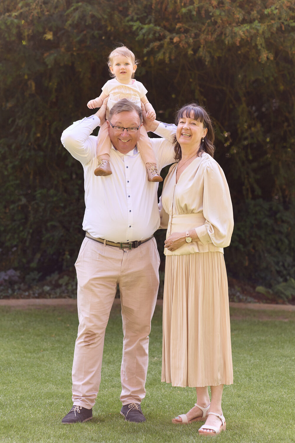 Family session — grandfather with grandchild on shoulders