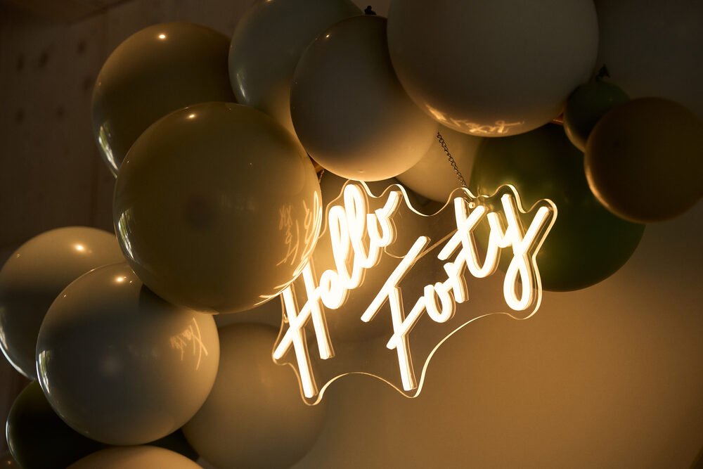 Private birthday celebration — neon sign and balloons