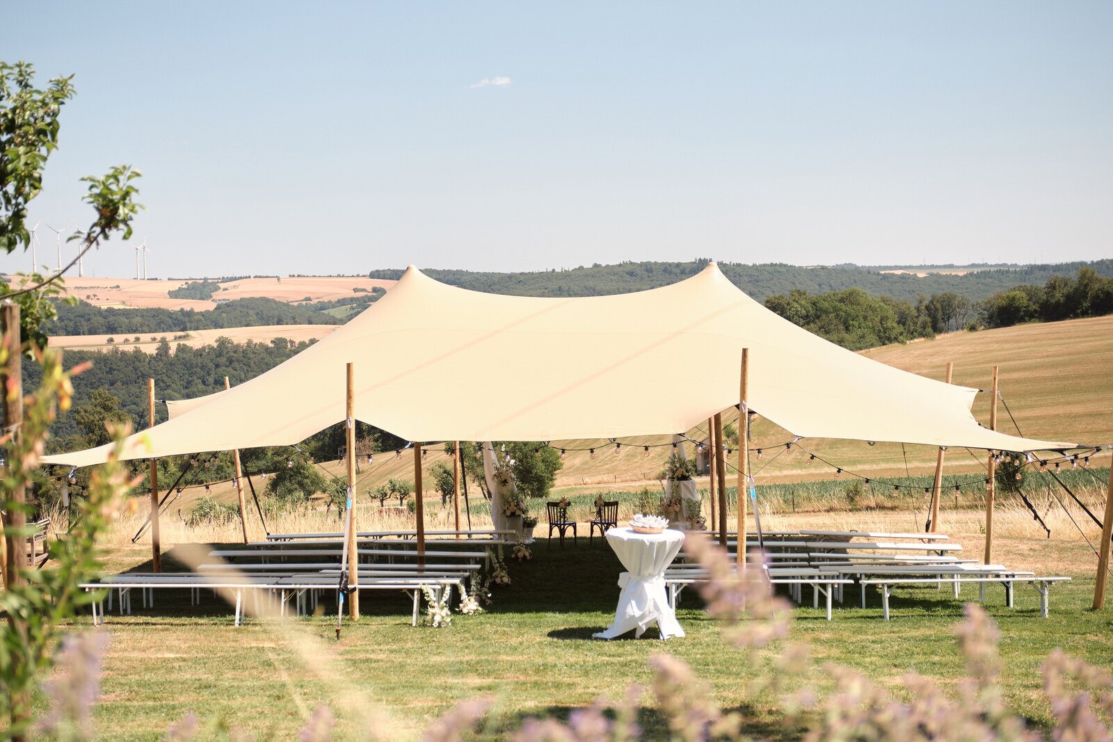 The stretch tent set for the ceremony on the lawn at Hazelnut House, above the Mullerthal valley