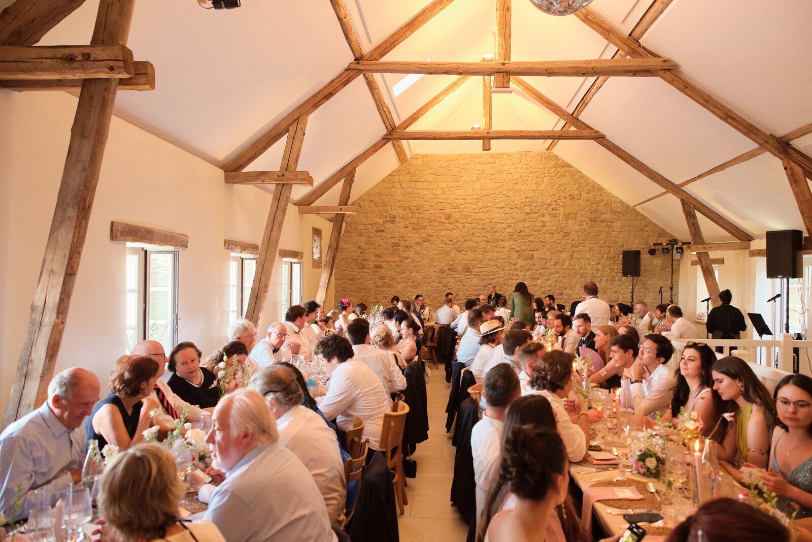 Wedding dinner under the timber roof of the barn at Hazelnut House