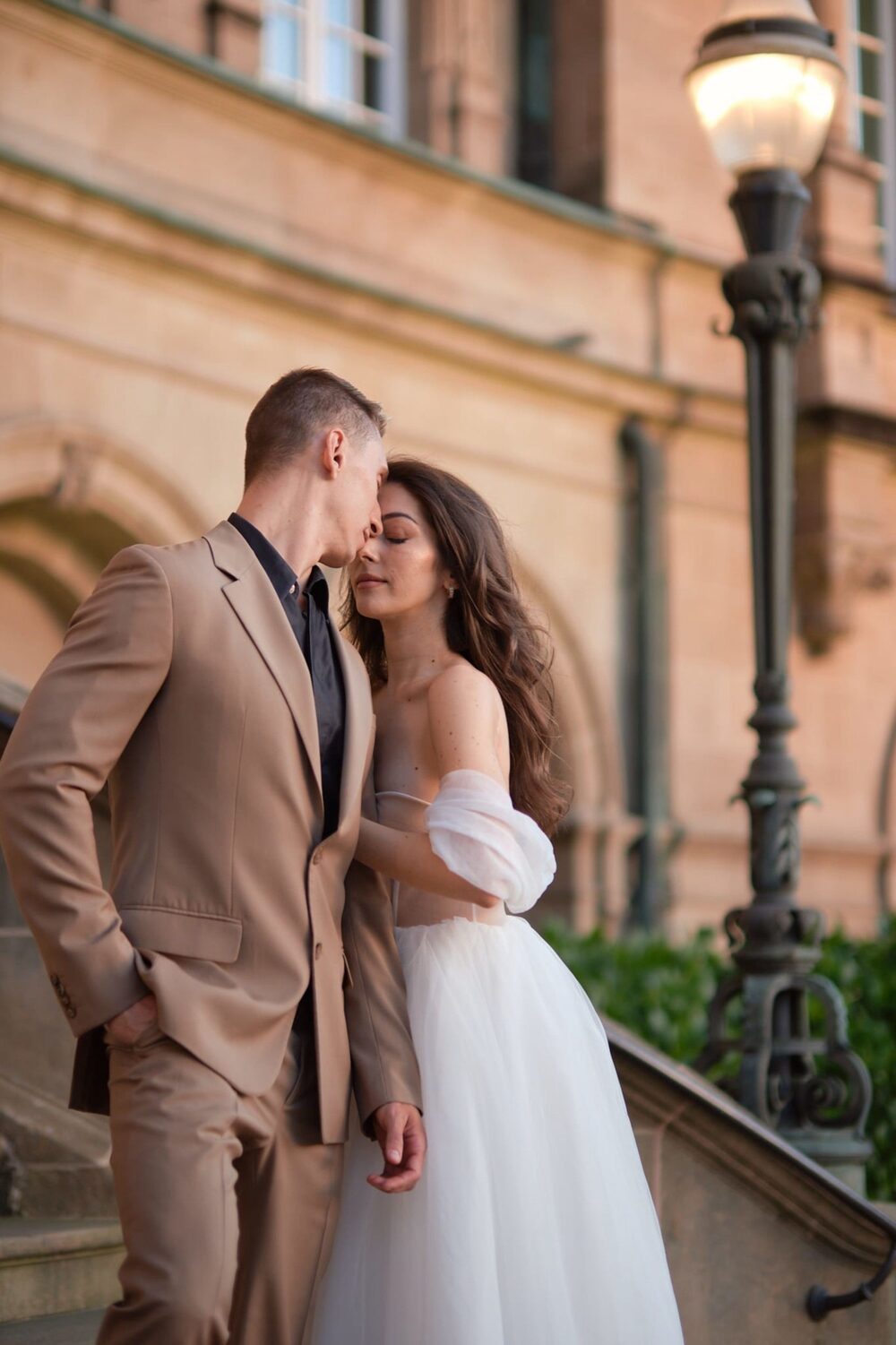 Groom helps bride with veil — moment